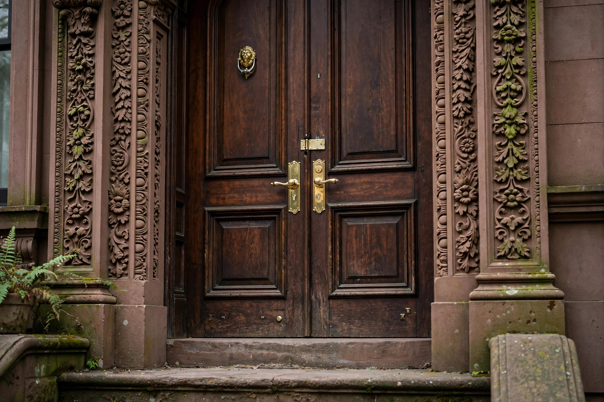 Row-house entrance with brass door hardware in East New York